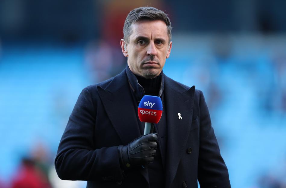 Gary Neville holding a Sky Sports microphone.