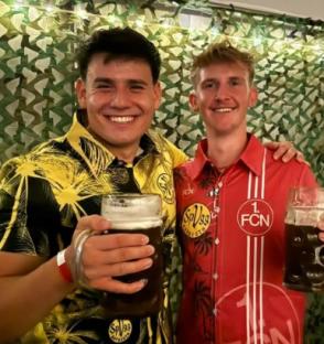 Two men holding beer steins.