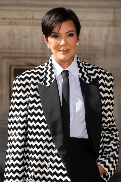 Kris Jenner in a black and white chevron sequined blazer and black tie.