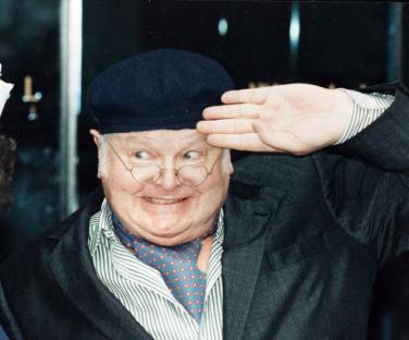 Benny Hill as Fred Scuttle saluting.