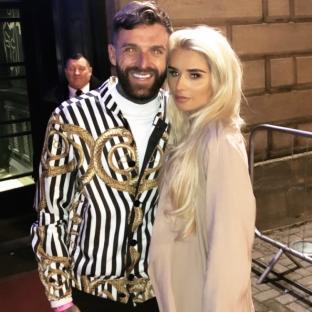 Aaron Chalmers and Talia Oatway posing for a photo.