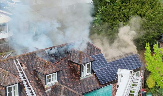 Smoke billows from a house fire.