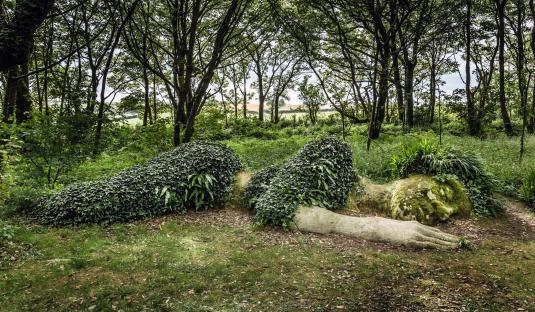 Mud Maid woodland sculpture covered in ivy at the Lost Gardens of Heligan.
