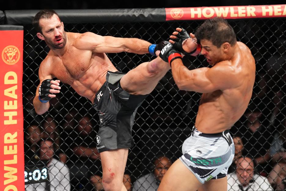 Luke Rockhold kicks Paulo Costa during a UFC middleweight fight.