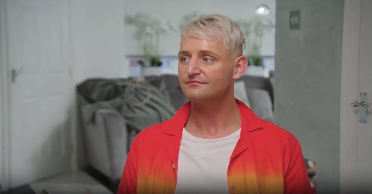 A man in a red and orange ombre shirt.