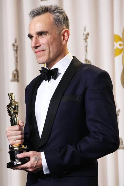 Daniel Day-Lewis holding an Oscar in the press room.