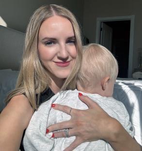Woman holding a toddler.