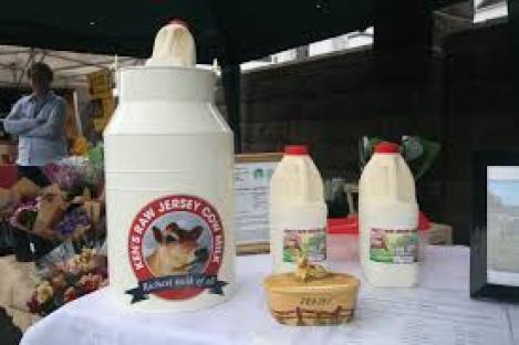 Ken's Raw Jersey Milk at a market stall.
