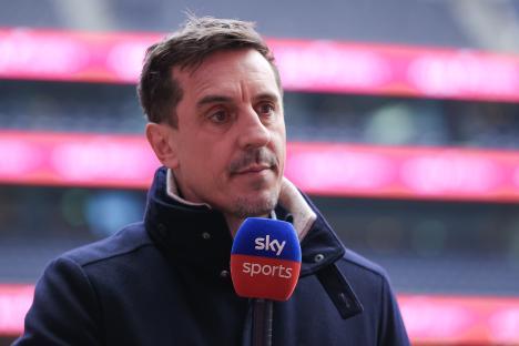 Gary Neville speaking into a Sky Sports microphone.