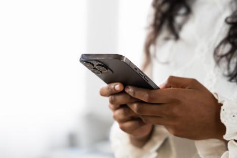 Close-up of hands using a smartphone.