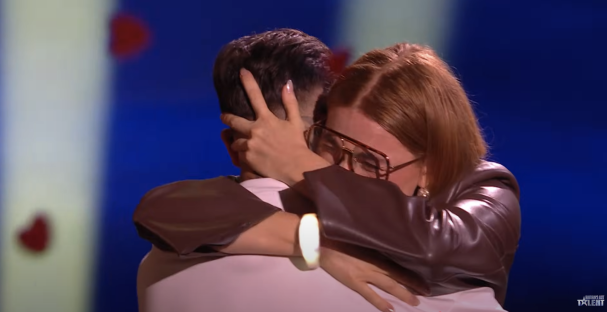 Screenshot of a woman hugging a man.