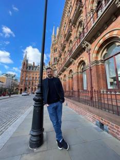 Rod McPhee standing outside a large brick building.