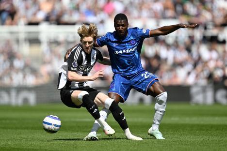 Anthony Gordon of Newcastle United challenged by Moises Caicedo of Chelsea during a Premier League match.