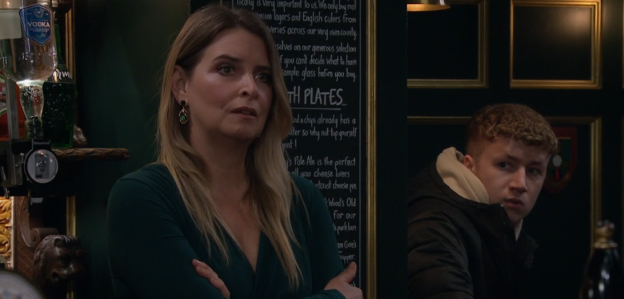 Screenshot of a woman and a young man in a pub.