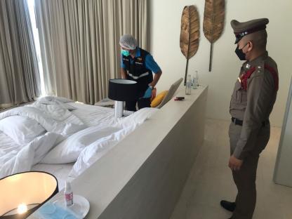 Forensic officers examining a hotel room.