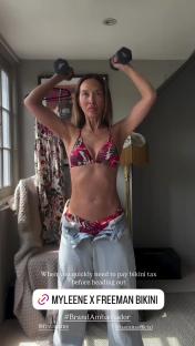 Woman in bikini lifting weights.