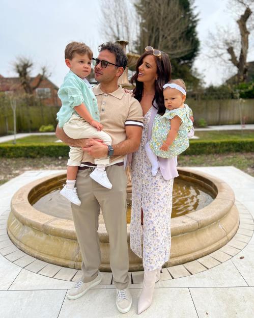 Family portrait by a fountain.