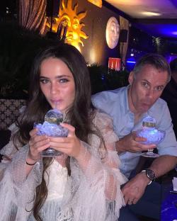 Mia Carragher and a man puckering their lips together.