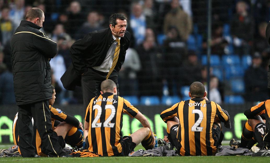 Soccer coach giving a halftime talk to his team.