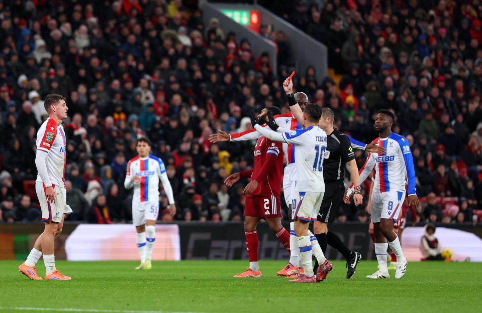 Referee Craig Pawson shows a red card during the Carabao Cup Fourth Round match between Liverpool and Crystal Palace.