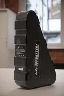 E-bike battery with warning label.