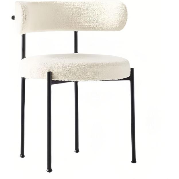 Cream boucle chair with black legs.