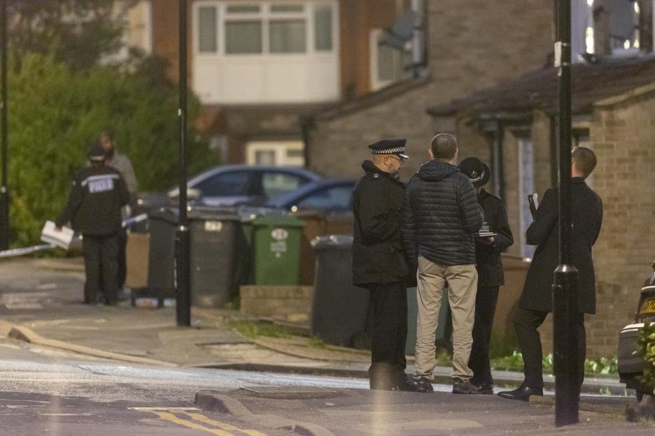 Police officers gathered at a crime scene in Walthamstow, London.