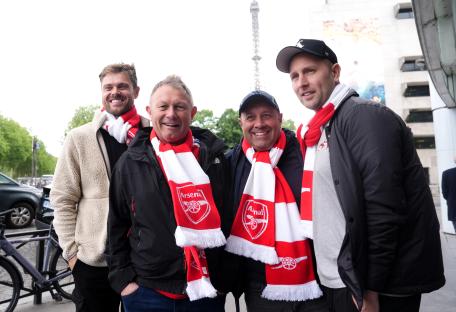 Four Arsenal fans in Paris wearing team scarves.