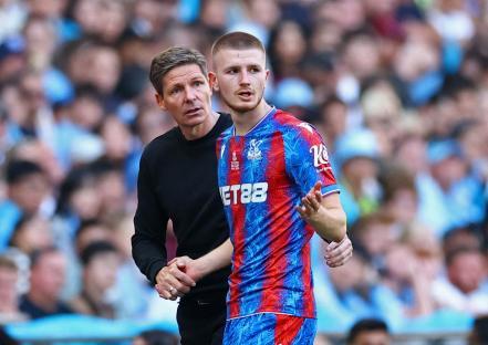 Adam Wharton of Crystal Palace shaking hands with his manager after being substituted.
