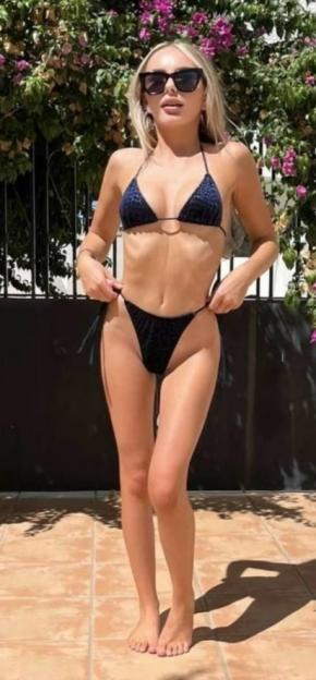 Woman in a black bikini and sunglasses.