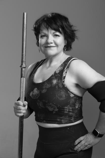 Black and white photo of a woman holding a barbell.