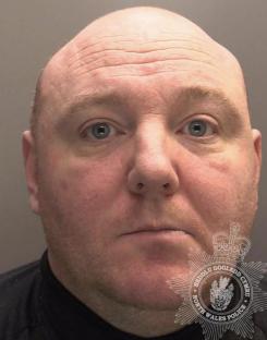 Mugshot of a bald man.