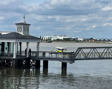 Police boat approaching a pier.