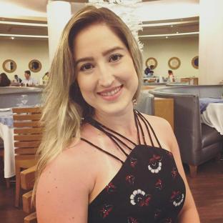 Professor Larissa Rodrigues in a restaurant.