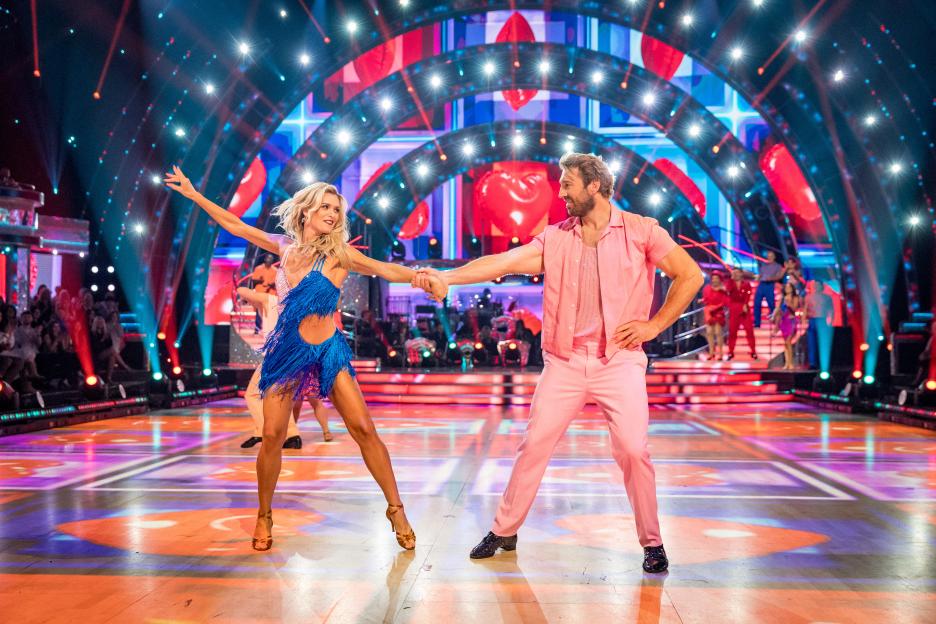 Nadiya Bychkova and Chris Robshaw dancing on a brightly lit stage.