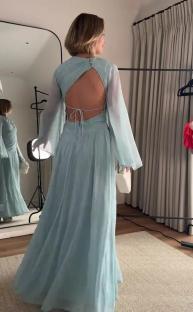 Woman in light blue backless gown.