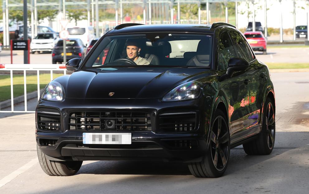 Man driving a black Porsche.