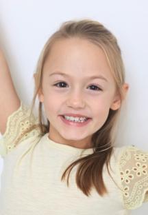 Headshot of Amelie Bea Smith, the fourth voice of Peppa Pig.