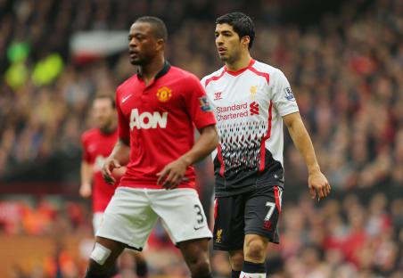 Patrice Evra of Manchester United and Luis Suarez of Liverpool during a soccer match.