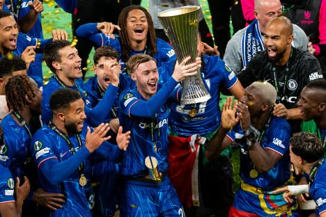 Cole Palmer of Chelsea lifts the UEFA Conference League trophy.