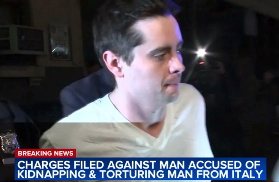 John Woeltz, accused of kidnapping and torturing an Italian man, being led away in handcuffs.
