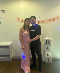 Pregnant woman and man at a baby shower.