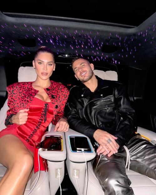 Lucas Hernandez and Victoria Triay Klein sitting in a car with a fiber optic lit ceiling.