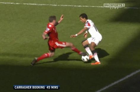 Soccer player receiving a booking.