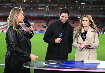 Mikel Arteta with two sports reporters at a Champions League match.