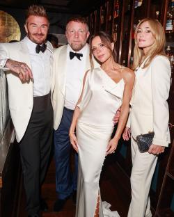 Victoria and David Beckham with friends at a celebration.