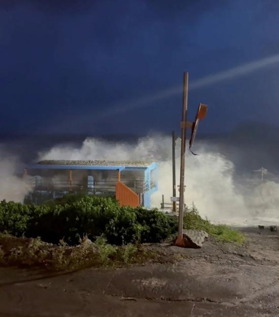 A huge wave crashes on a structure on Orchid Island, Taitung County, Taiwan.