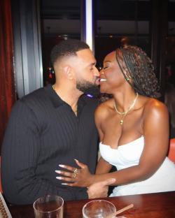 Couple kissing at a restaurant.