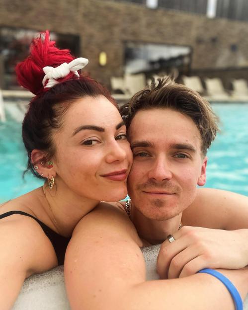 Dianne Buswell and Joe Sugg smiling and embracing in a spa.