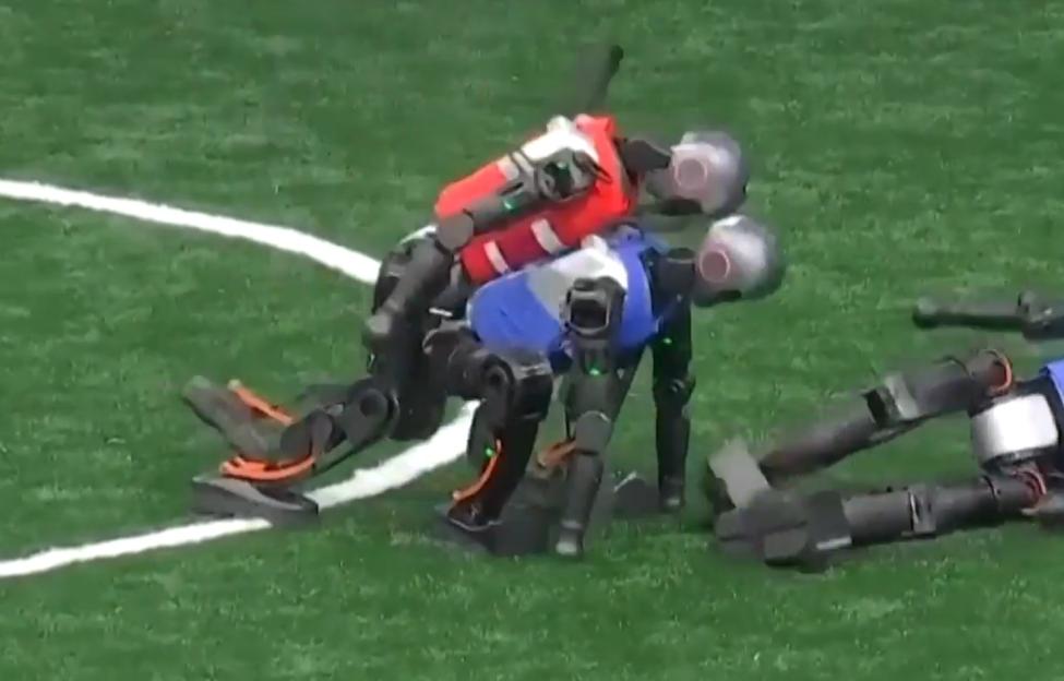 Robots falling during a soccer game.